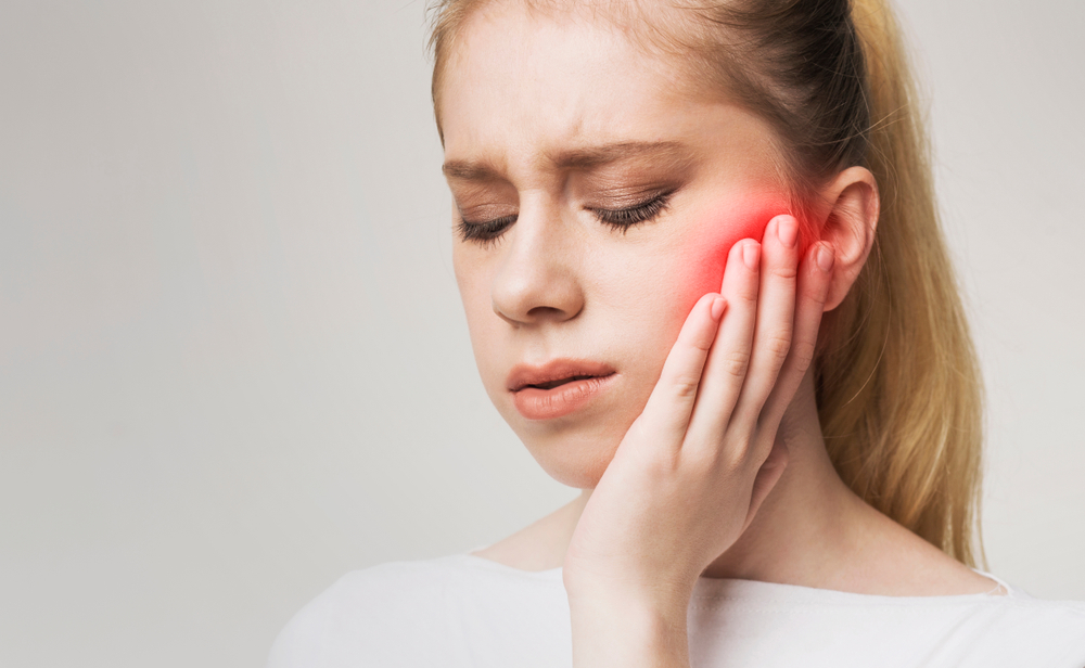 Young,Woman,Touching,Her,Cheek,,Having,Strong,Toothache,And,Suffering