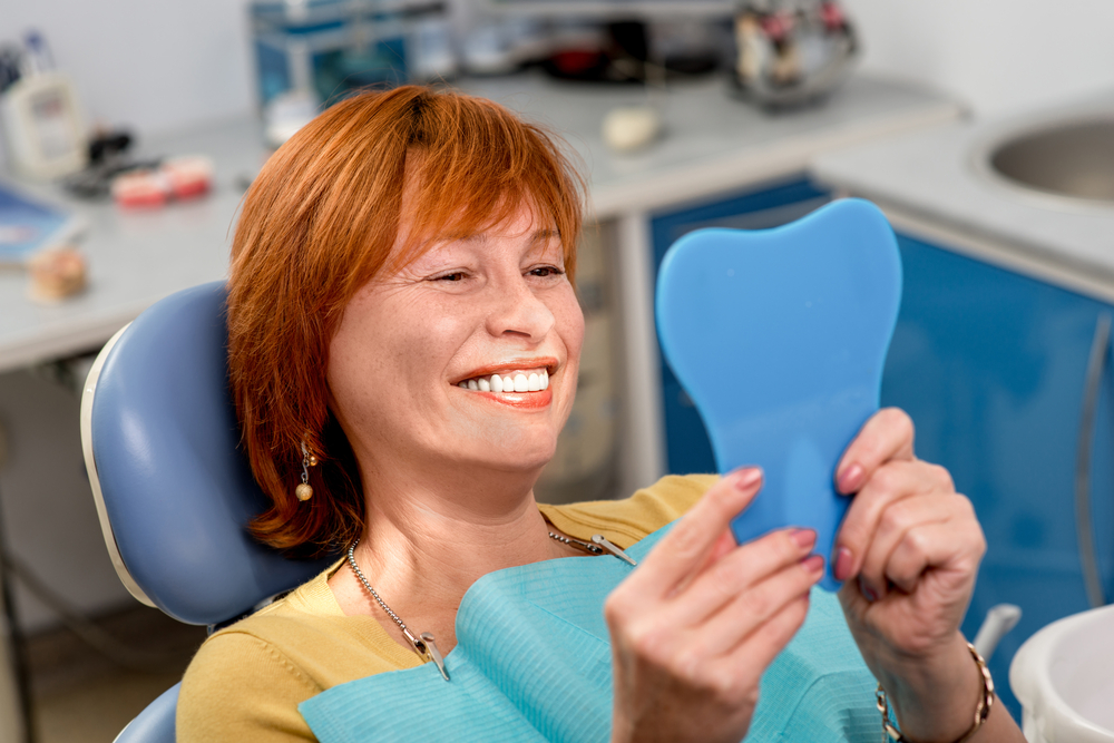 Smiling,Senior,Woman,With,New,Dental,Implants,Sitting,In,The