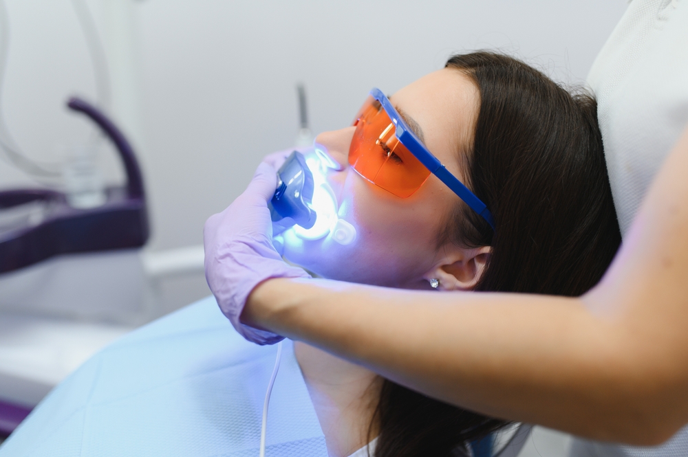Girl,Patient,In,The,Dental,Clinic.,Teeth,Whitening,Uv,Lamp