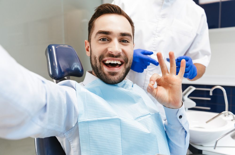 Image,Of,Brunette,Young,Man,Sitting,In,Dental,Chair,At
