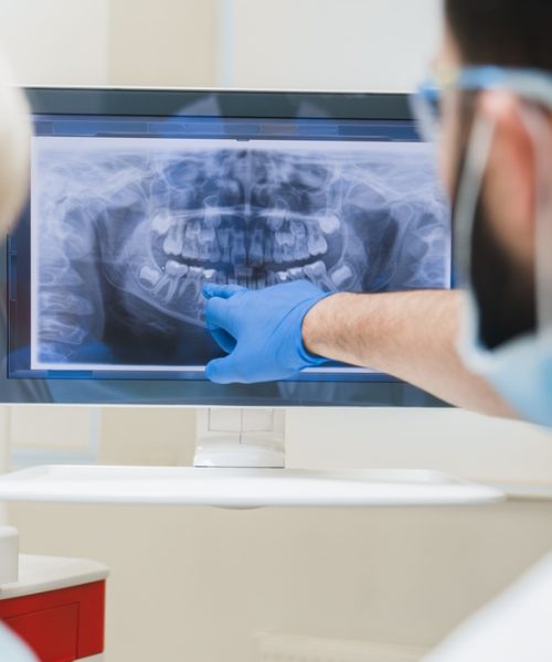 Back,View,Shot,Of,Male,Dentist,Orthodontist,Showing,Explaining,An